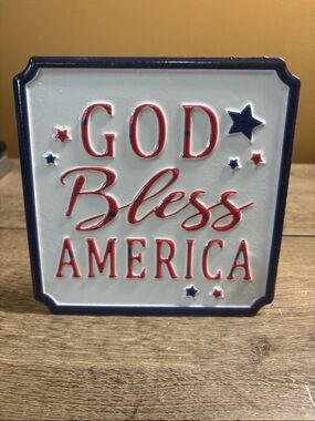 patriotic metal sign features a white background with navy blue and red accents